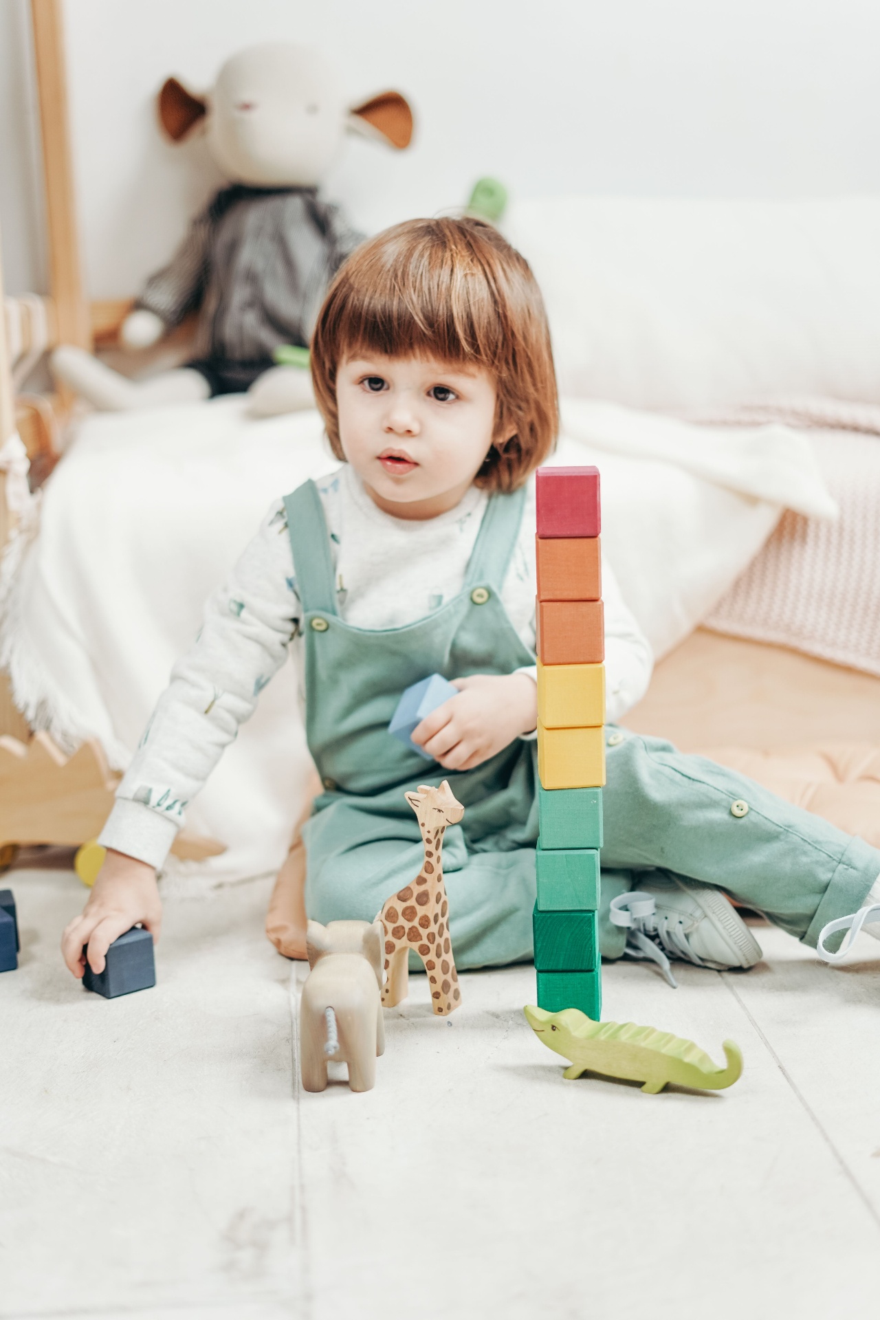 Child stacking colourful blocks at play